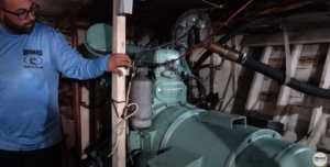 Captain David from the Reward Fishing Fleet in Miami, Florida showcases a Detroit Diesel 271 Generator from inside the engine room of the vessel Another Reward.